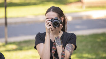 Student holding a camera